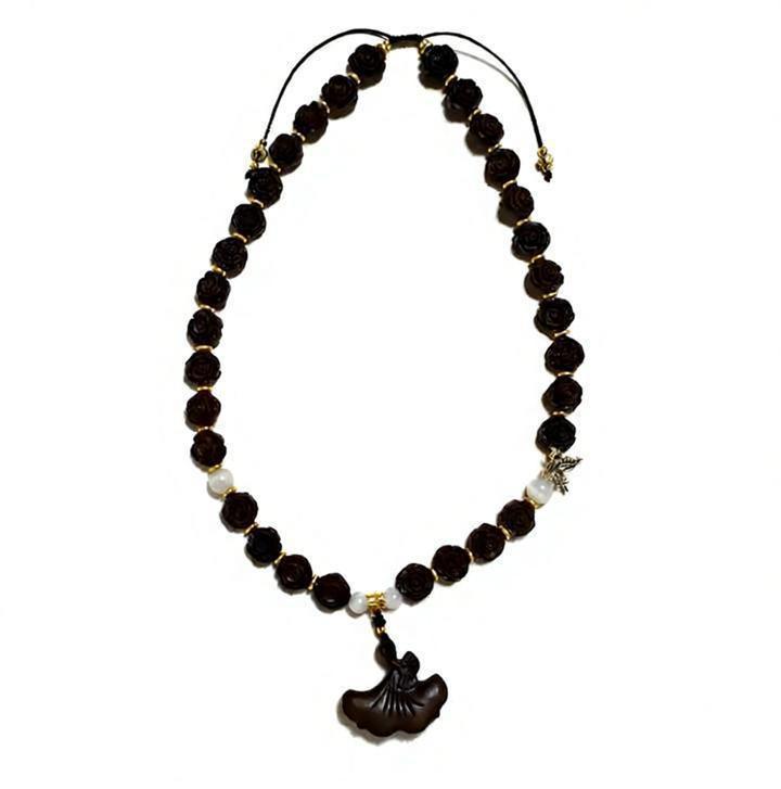 Full view of the Zhiji Midnight Bloom Necklace, showcasing the handcrafted herbal rose beads and butterfly charm. A piece of custom aromatherapy jewelry.